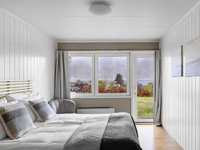 a bedroom with a bed and a large window at Eidfjord Hotel in Eidfjord