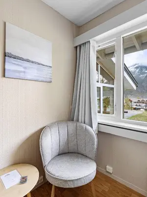 a chair in a room with a window at Eidfjord Hotel in Eidfjord