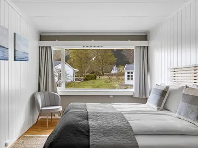 a bedroom with a bed and a large window at Eidfjord Hotel in Eidfjord