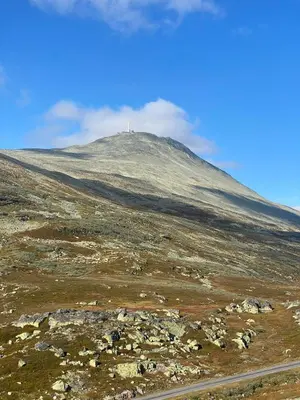 a hill with a cross on top of it at Gaustablikk Sportshytte midt i naturen in Rjukan