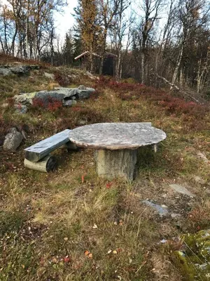 a stone bench sitting on top of a hill at Cabin in the Mountain, with Solar Energy in Slidre