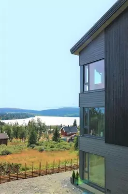 a house with a view of a field and a lake at Leilighet med panoramautsikt Sjusjøen Innendørs parkering in Sjusjøen