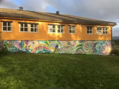 a building with a mural on the side of it at Nye Heimen Overnatting in Namsos