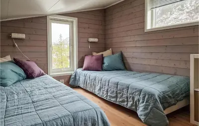a bedroom with two beds and a window at Gorgeous Home In Revsnes With Wifi in Refsnes