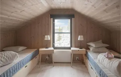 two beds in a room with a window at 4 Bedroom Lovely Home In Østby in Østby