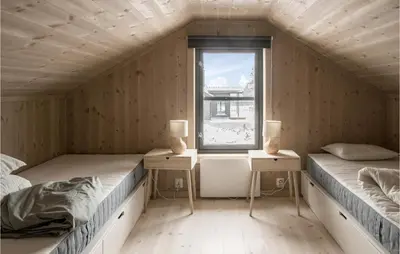a room with two beds and a window at 4 Bedroom Lovely Home In Østby in Østby