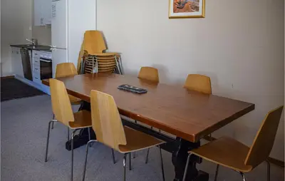 a wooden table and chairs in a room at Hovden Alpin Apartments in Hovden