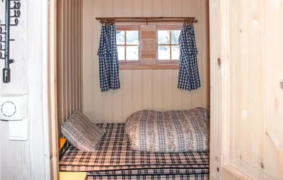 a small bed in a small room with a window at Cozy Home In Tuddal With Kitchen in Tuddal
