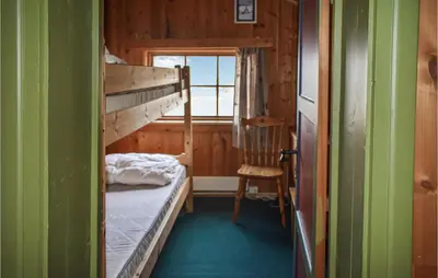 a small room with a bunk bed and a chair at 2 Bedroom Stunning Home In Rauland in Rauland