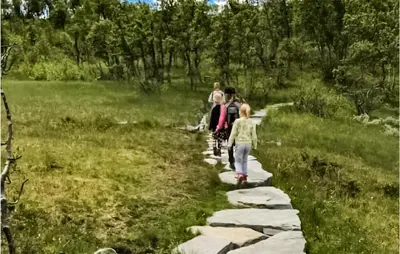 a group of people walking on a rock path at 2 Bedroom Stunning Home In Rauland in Rauland