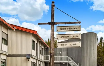 a pole with street signs in front of a building at 2 Bedroom Stunning Home In Rauland in Rauland