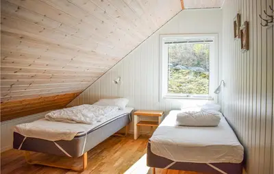 a bedroom with two beds and a window at 4 Bedroom Lovely Home In Vikebygd in Vikebygd