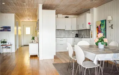 a kitchen and dining room with a table and chairs at 4 Bedroom Lovely Home In Vikebygd in Vikebygd