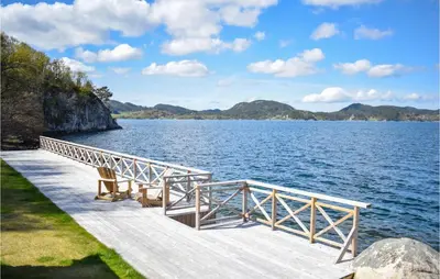 a dock on a large body of water at 4 Bedroom Lovely Home In Vikebygd in Vikebygd