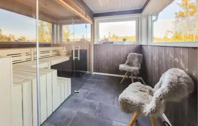 a room with two chairs and a window at Nice Home In Sjusjoen in Sjusjøen