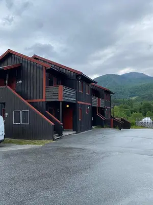 a barn with a car parked in front of it at Brobygget Mølla 101 in Kyrkjebøen