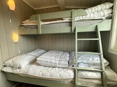 a bunk bed with a ladder in a room at Kvetos fjellhytte in Beitostøl