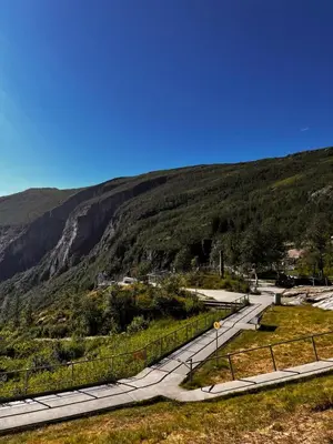 a winding road with a mountain in the background at Cozy house in Eidfjord in Eidfjord