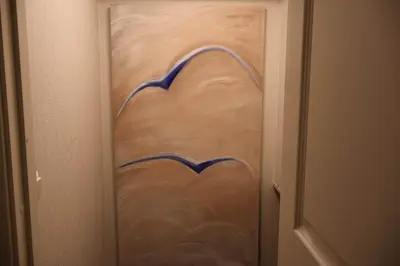 a door with a painting on it in a room at Dinbnb Apartments I Charming 3-Bedroom in the Heart of the City in Bergen