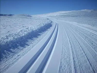 a road covered in snow with a group of cars at Actif 106 - Hallingheim apartment ski inn/ski ut in Ål