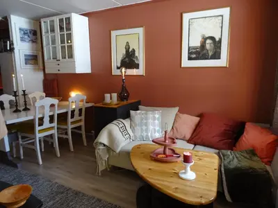 a living room with a couch and a table at Actif 106 - Hallingheim apartment ski inn/ski ut in Ål