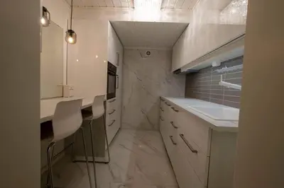 a kitchen with white cabinets and a sink and counters at Koselig leilighet i rolig boligfelt in Gol