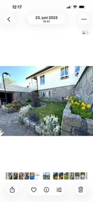 a picture of a house with flowers in the yard at Koselig leilighet i rolig boligfelt in Gol