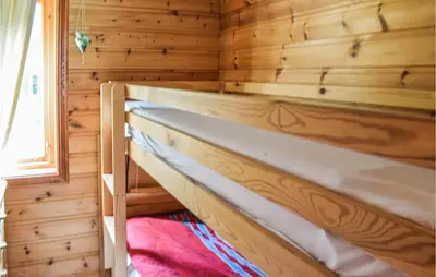 a bedroom with a bunk bed in a log cabin at Stunning Home In Førde I Hordaland in Lier