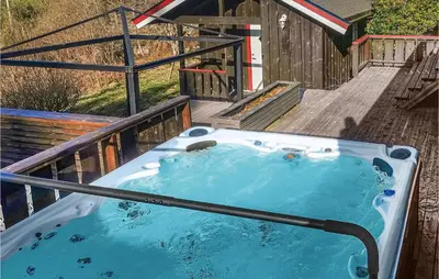 a jacuzzi tub on a wooden deck at Cozy Home In Meisingset With Kitchen in Meisingset