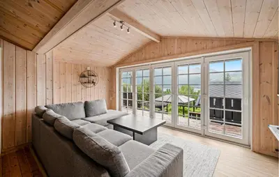 a living room with a couch and a table at Cozy Home In Meisingset With Kitchen in Meisingset