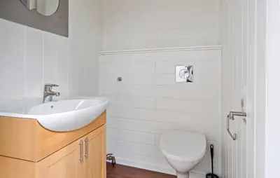 a bathroom with a white sink and a toilet at Cozy Home In Meisingset With Kitchen in Meisingset