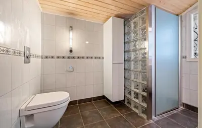 a bathroom with a toilet and a glass shower at Cozy Home In Meisingset With Kitchen in Meisingset