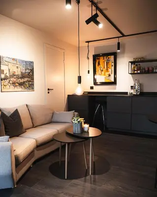 a living room with a couch and a table at Studio Leilighet, nyoppusset in Langevåg