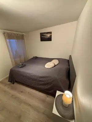 a bedroom with a bed with two pillows on it at Litle cozy apartment in Ålesund in Ålesund