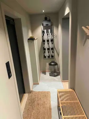 a hallway with two rugs and two benches in a room at SKI INN/OUT - 4-room apartment w/3 bedroom in Gaustablikk