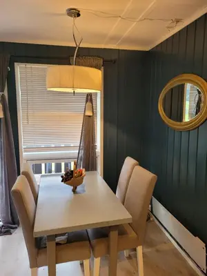 a dining room with a table and chairs and a mirror at Friends & Family Apartment at Hafjell Alpinlandsby/Øyer Center in Hafjell