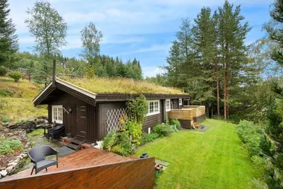 a small house with a grass roof at Gaulabua - cozy cabin by the river Gaula in Haltdalen