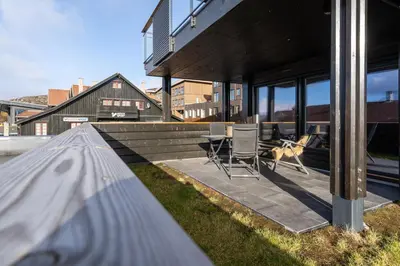 a house with a patio with a table and chairs at Riddertunets glimt in Beitostøl