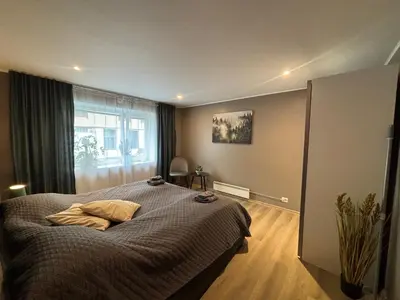 a bedroom with a bed and a large window at 3 rooms apartment in Center in Ålesund