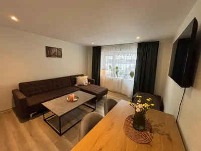 a living room with a couch and a table at 3 rooms apartment in Center in Ålesund