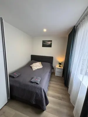 a small bedroom with a bed and a window at 3 rooms apartment in Center in Ålesund