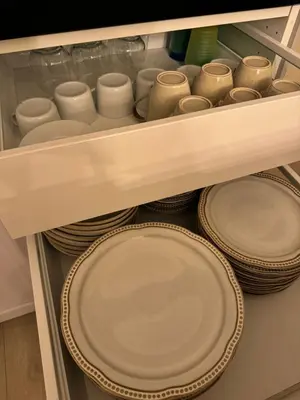 a drawer filled with plates and cups andplates at Chalet Orkanger - Close to Everything, Far from Ordinary in Orkanger