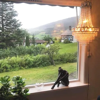 a statue of a chimpanzee sitting on a window sill at Store Ringheim Apartment - Villa Hjadlane in Vossevangen