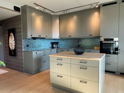 a kitchen with white cabinets and a counter top at Riddertunets harmoni in Beitostøl