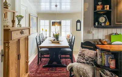 a dining room with a table and chairs at 3 Bedroom Gorgeous Home In Molde in Molde