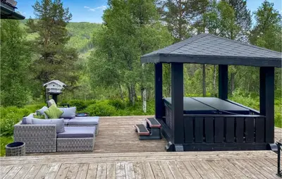a gazebo sitting on a wooden deck with a couch and a couch at 3 Bedroom Gorgeous Home In Molde in Molde