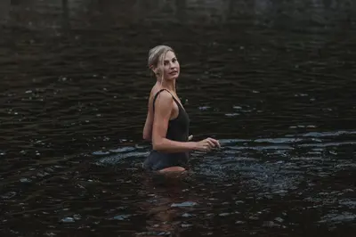 a woman standing in the water in the water at Ådalsvollen Retreat in Verdal