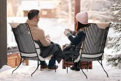 a man and a woman sitting in chairs in the snow at Ådalsvollen Retreat in Verdal