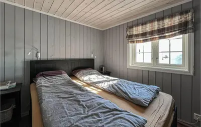 a bed in a bedroom with a window at Amazing Home In Sjusjøen With Sauna in Sjusjøen