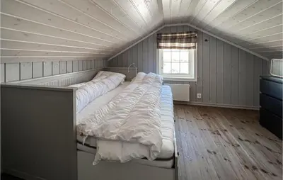 a bedroom with three beds in a room with a ceiling at Amazing Home In Sjusjøen With Sauna in Sjusjøen